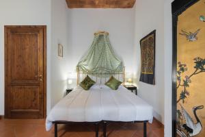 een slaapkamer met een wit bed en een baldakijn bij La Ginestra di Valerio - Chianti villa with large Pool & Wifi in Zambra