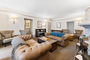 a living room with couches and a fireplace at The Rosevine in Porthscatho