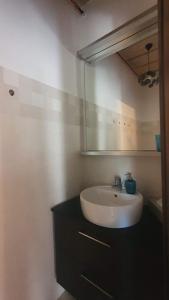 a bathroom with a sink and a mirror at Mayday Cottage in Pócsmegyer +28 photos
