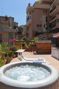 a hot tub sitting on top of a patio at Penthouse with Jacuzzi on Private Terrace in Trastevere in Rome