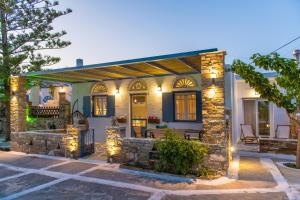 a house with lights on the front of it at Θἔρως (Theros) house 3- Agios Fokas in Agios Sostis