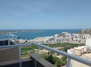 a view of the ocean from the balcony of a building at Hotel VIU57 in Mellieħa