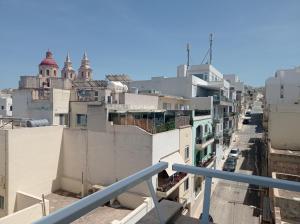 a view of a city street from a balcony at Hotel VIU57 in Mellieħa