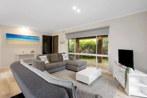a living room with a couch and a tv at Sorrento Lifestyle Awaits in Sorrento