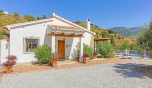 a small white house with a patio at Casa Eve - Beautiful Villa & Heated - Pool to Yourself in Árchez