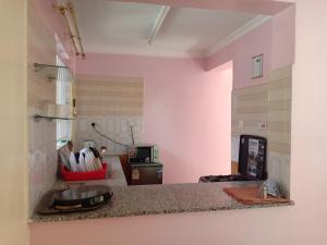 a kitchen with a counter with a sink at Tommy's Lounge Apartments in Nairobi