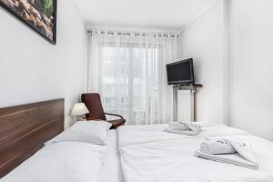 Łóżko lub łóżka w pokoju w obiekcie Apartamenty Casa Marina
