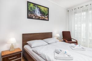Łóżko lub łóżka w pokoju w obiekcie Apartamenty Casa Marina