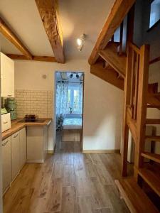 a kitchen with wooden floors and a staircase in a room at Agroturystyka u Beci in Sorkwity