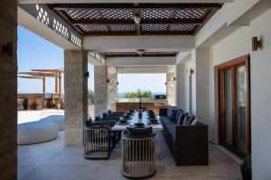 an outdoor dining room with a long table and chairs at Alpha Estate & Spa in Rethymno