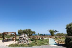 a garden with a swimming pool and a park at Alpha Estate & Spa in Rethymno +75 photos