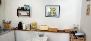 a kitchen with a counter with a sink and a counter top with a counter at Le Gite de Lili in Acquigny +25 photos