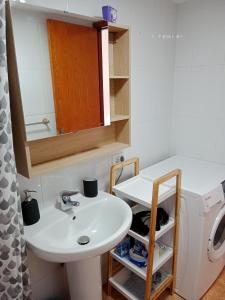 a bathroom with a sink and a washing machine at EL MORRO SEA VIEW APARTMENT in San Agustin +16 photos