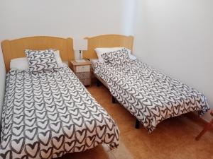 two beds sitting next to each other in a room at EL MORRO SEA VIEW APARTMENT in San Agustin