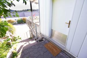an open door to a porch with a sign on it at Hilltop-house, near train, 180° panorama, friendly in Birmensdorf