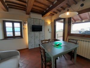a kitchen and dining room with a table and chairs at Casa Torre in Arezzo