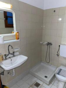 a bathroom with a sink and a toilet at Livadia Studios in Ropanianá