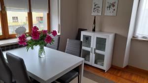 a dining room with a white table with flowers on it at Casa Germana in Invorio Inferiore