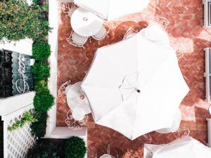 an overhead view of a white umbrella on a patio at Hotel des Lices in Saint-Tropez