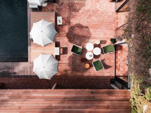 an overhead view of a table with umbrellas on a patio at Hotel des Lices in Saint-Tropez