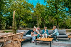 a group of children sitting on a couch at EuroParcs Ruinen in Ruinen