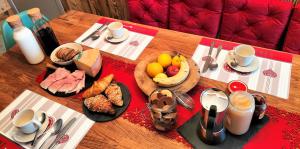 a table with breakfast foods and coffee on it at B&B Le Fió in Valtournenche