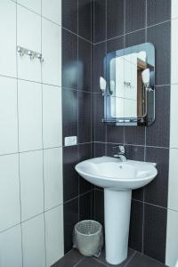 a bathroom with a sink and a mirror at Syuniq Hotel in Goris