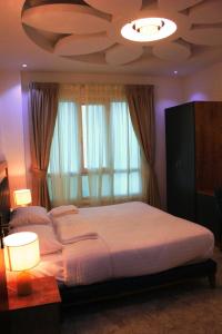 Postel nebo postele na pokoji v ubytování ريلاكس إن للشقق الفندقية Relax Inn Hotel Appartment