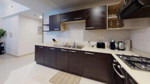 a kitchen with a sink and a counter top at Hometown Apartments Trendy One Bed Apt in Ontario Tower in Dubai