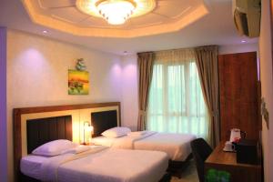 Postel nebo postele na pokoji v ubytování ريلاكس إن للشقق الفندقية Relax Inn Hotel Appartment