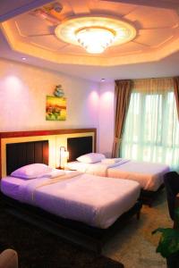 Postel nebo postele na pokoji v ubytování ريلاكس إن للشقق الفندقية Relax Inn Hotel Appartment