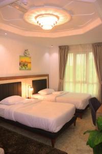 Postel nebo postele na pokoji v ubytování ريلاكس إن للشقق الفندقية Relax Inn Hotel Appartment