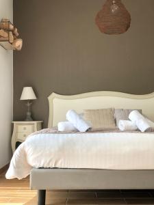 a bedroom with a bed with white sheets and pillows at L'estacade in Le Croisic