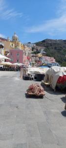 a group of tents sitting on a patio with a city at Happy House Corricella in Procida