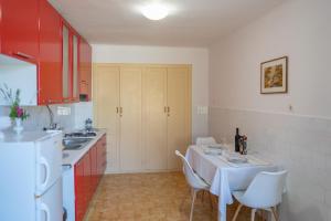 a kitchen with a table and chairs and a refrigerator at MAZZA charming sea view Apartment,House Cavtat - Center in Cavtat +14 photos