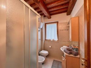 a bathroom with a toilet and a sink at Villetta Oreste in Saturnia