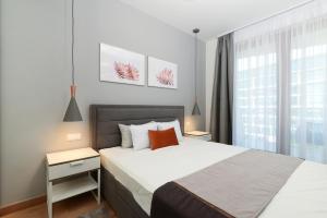 Posteľ alebo postele v izbe v ubytovaní Silver Home Apartments