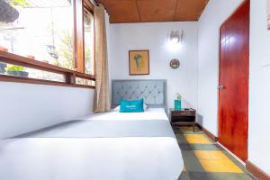 Postel nebo postele na pokoji v ubytování Ayenda Sarayu House