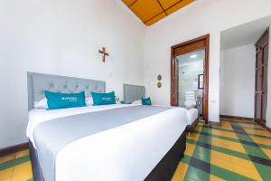 Postel nebo postele na pokoji v ubytování Ayenda Sarayu House