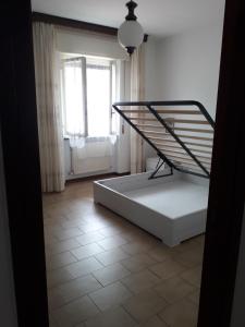 a bed sitting in a room with a window at La casa di Alice e Matteo in Casarza Ligure