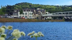 a bridge over a large body of water with houses at Numéro 1 in Châteaulin