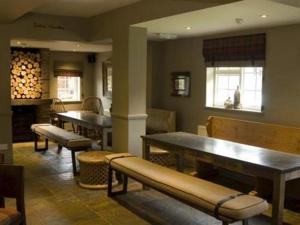 a room with a table and chairs in it at The Percy Arms in Guildford