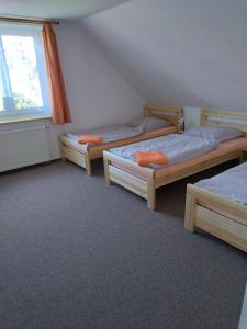 מיטה או מיטות בחדר ב-Penzion HORTENZIE