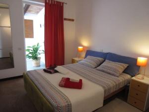 a bedroom with a bed with a red purse on it at Tranquility?JUST RELAX on the NON-TOURISTIC COAST in Colonia de Sant Pere +32 photos