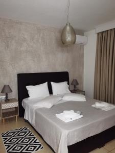 a bedroom with a large bed with two towels on it at Villa Gallen in Limenas