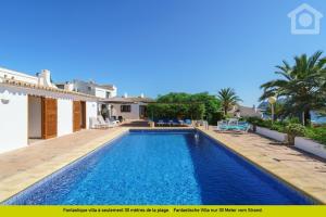 a villa with a swimming pool and a house at SolHabitat Villa La Andana in Benissa