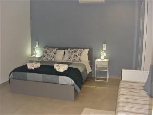 a bedroom with a large bed with two night stands at apartments e beb kiss under the moon in Lesina
