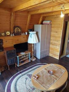 a living room with a table and a stove at Jovana in Nova Varoš