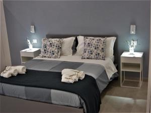 a bedroom with a large bed with towels on it at apartments e beb kiss under the moon in Lesina