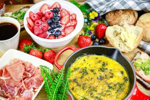a table topped with a buffet of food with fruit and bread at Saimaa Experience in Savonlinna +7 photos